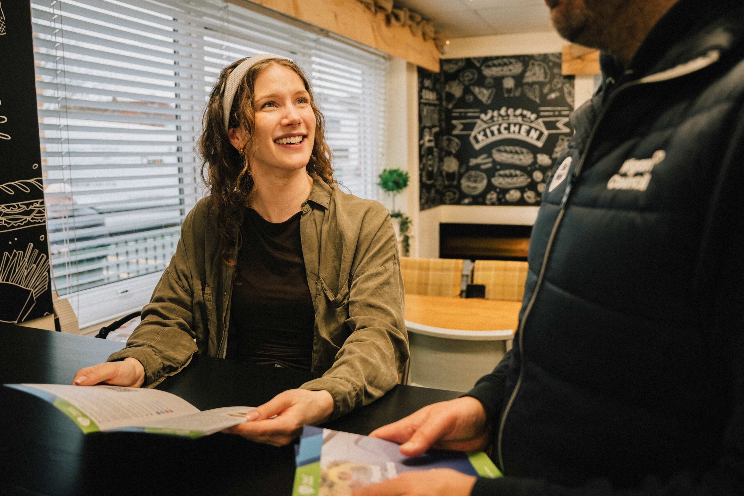 Smiling woman with a healthy eating guide