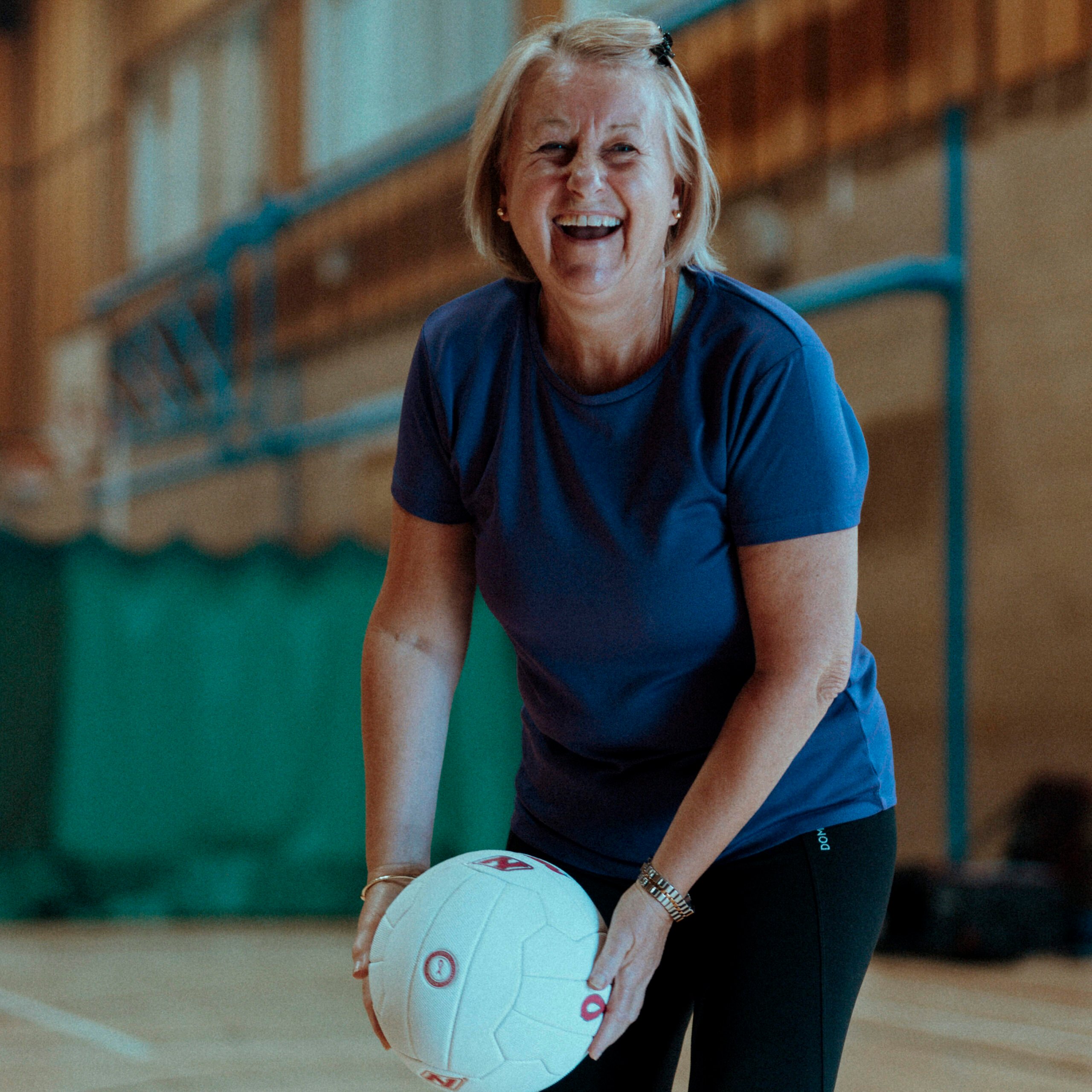 a woman taking a picture with a basketball