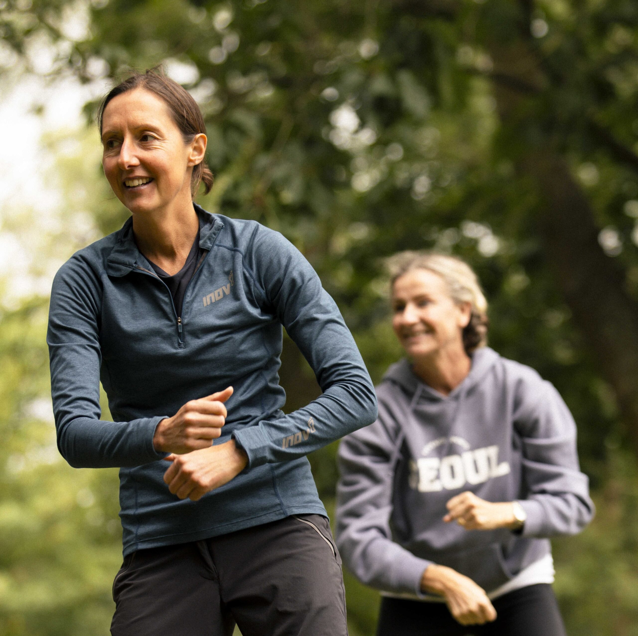Two women at a group exercise class in a park