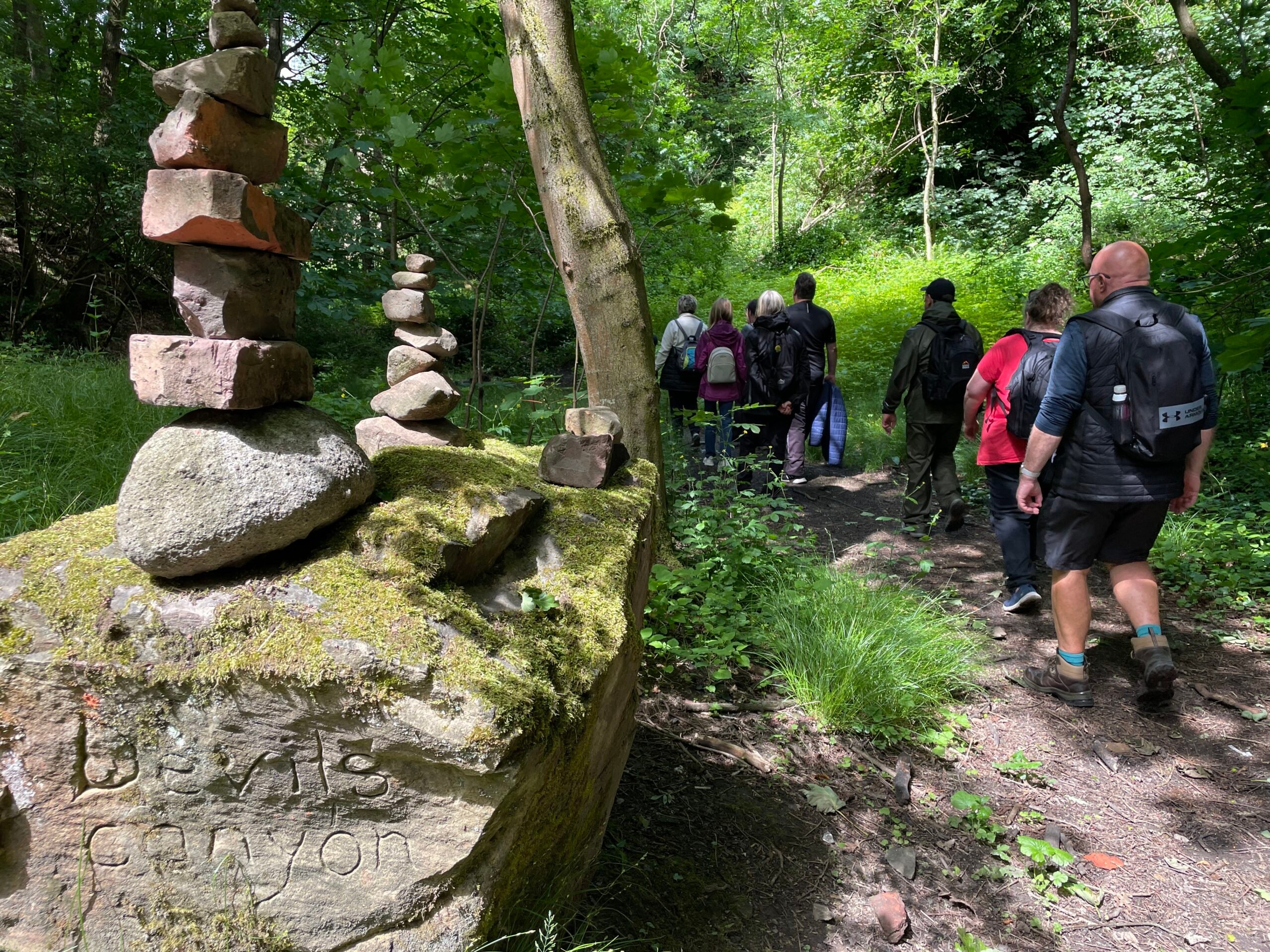 A group of walkers pass 'Devil's Canyon' on the Wigan Way