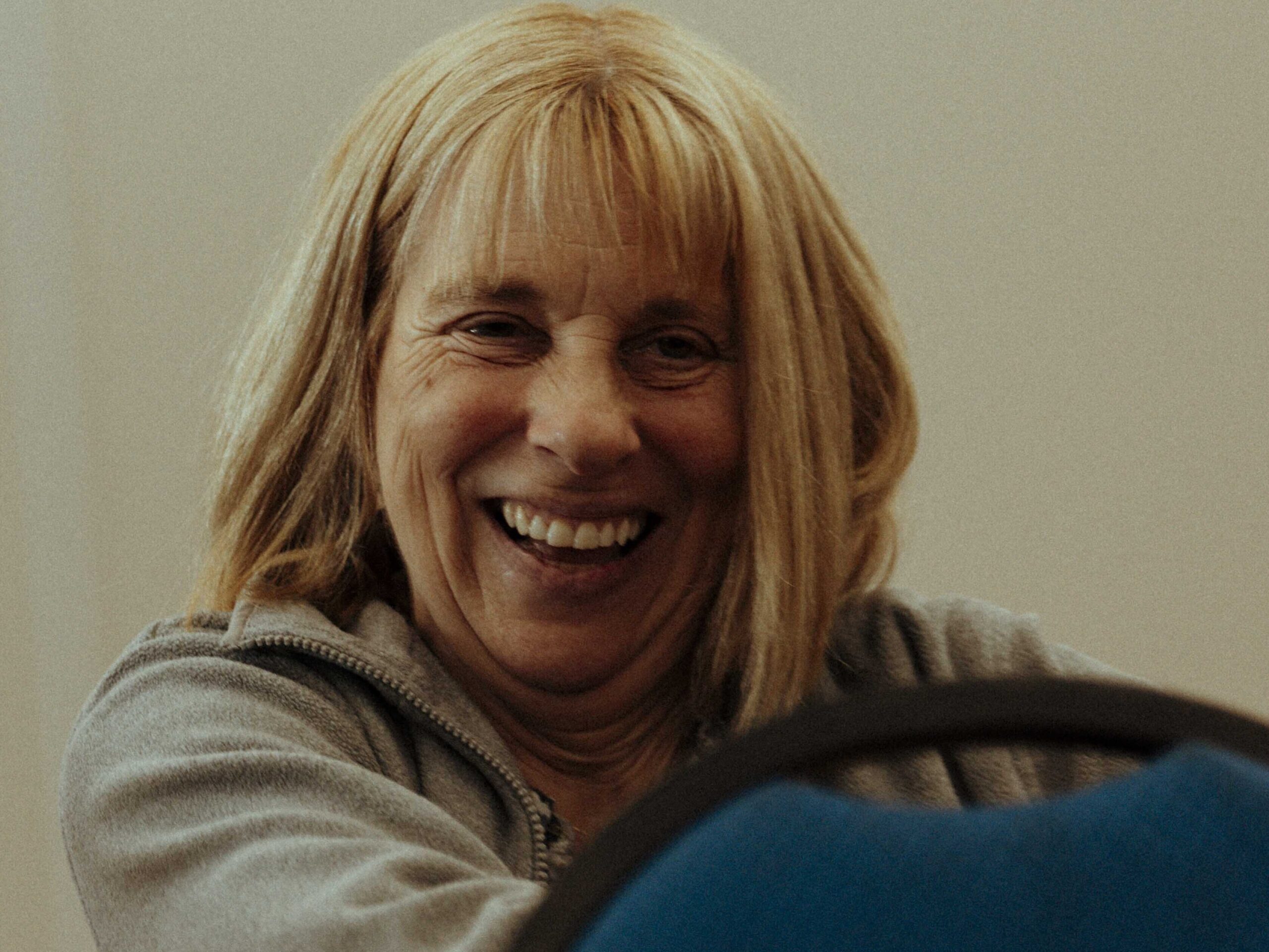 A smiling woman at a group exercise class