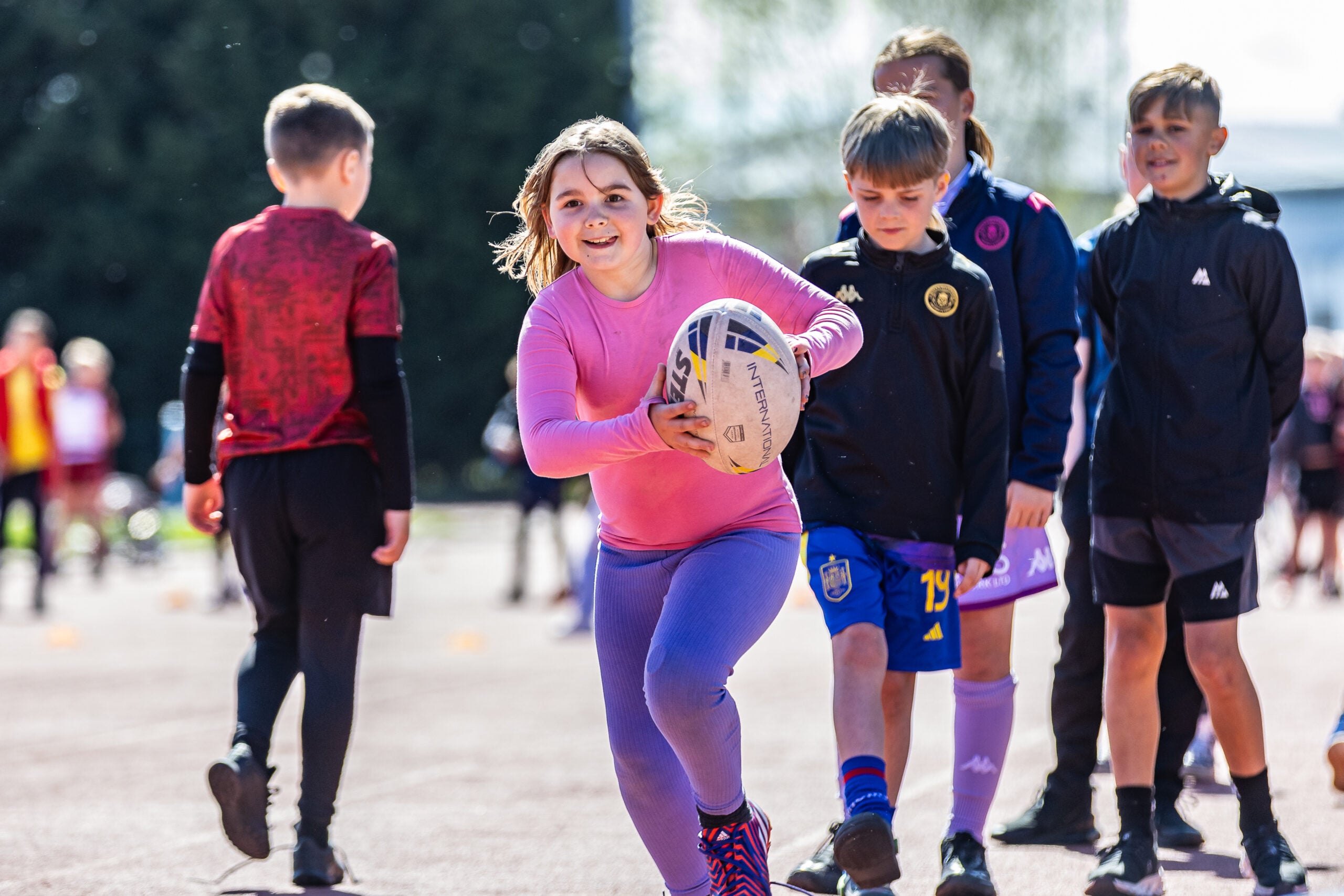 Girl playing rugby at a HAF camp