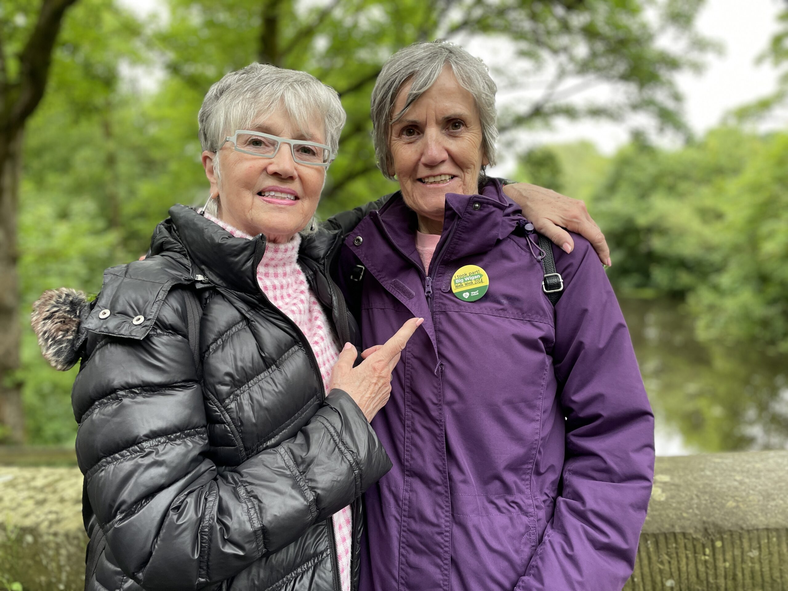 A walker with a Big Wigan Walk Week badge