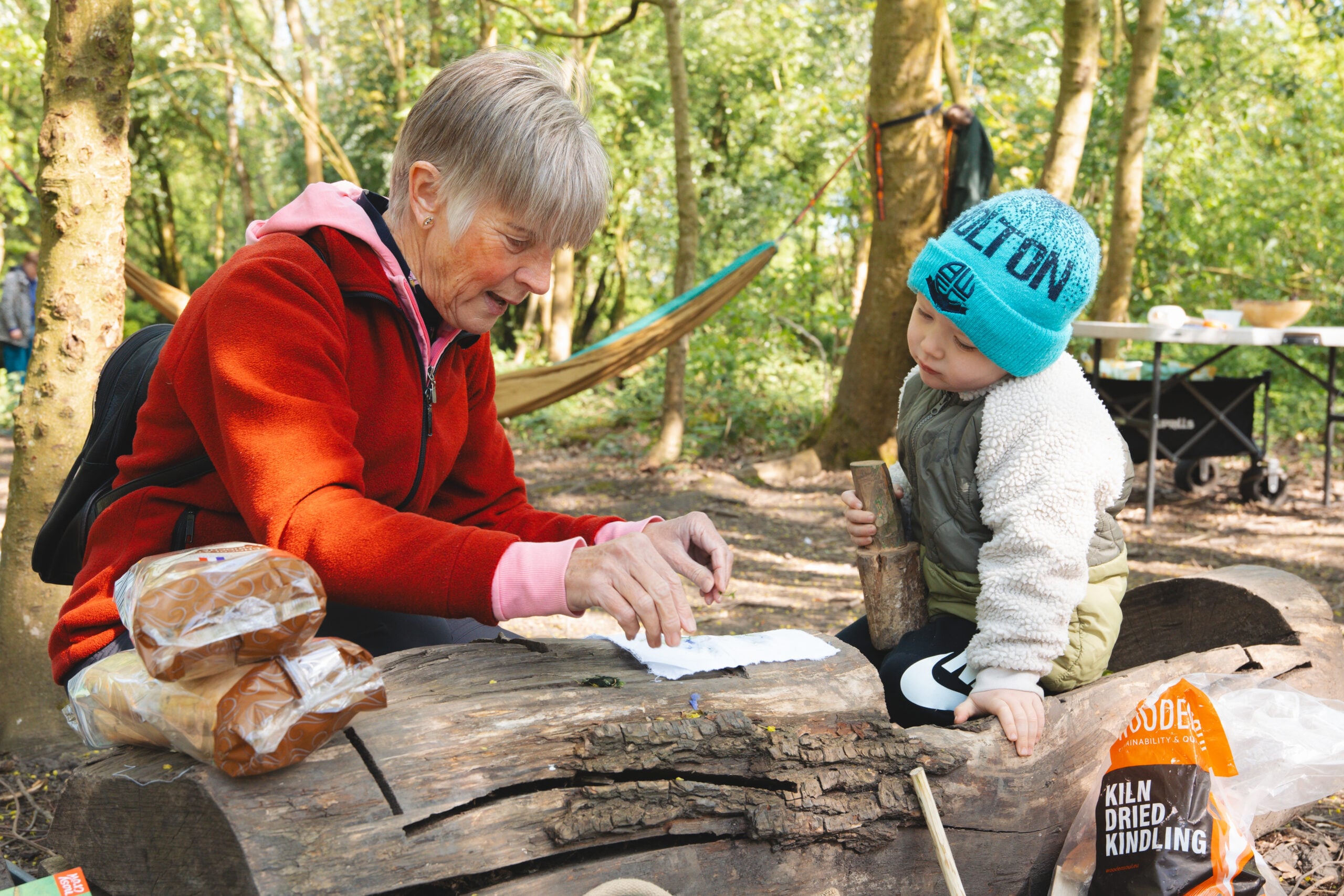 A young boy and his grandmother doing leaf printing