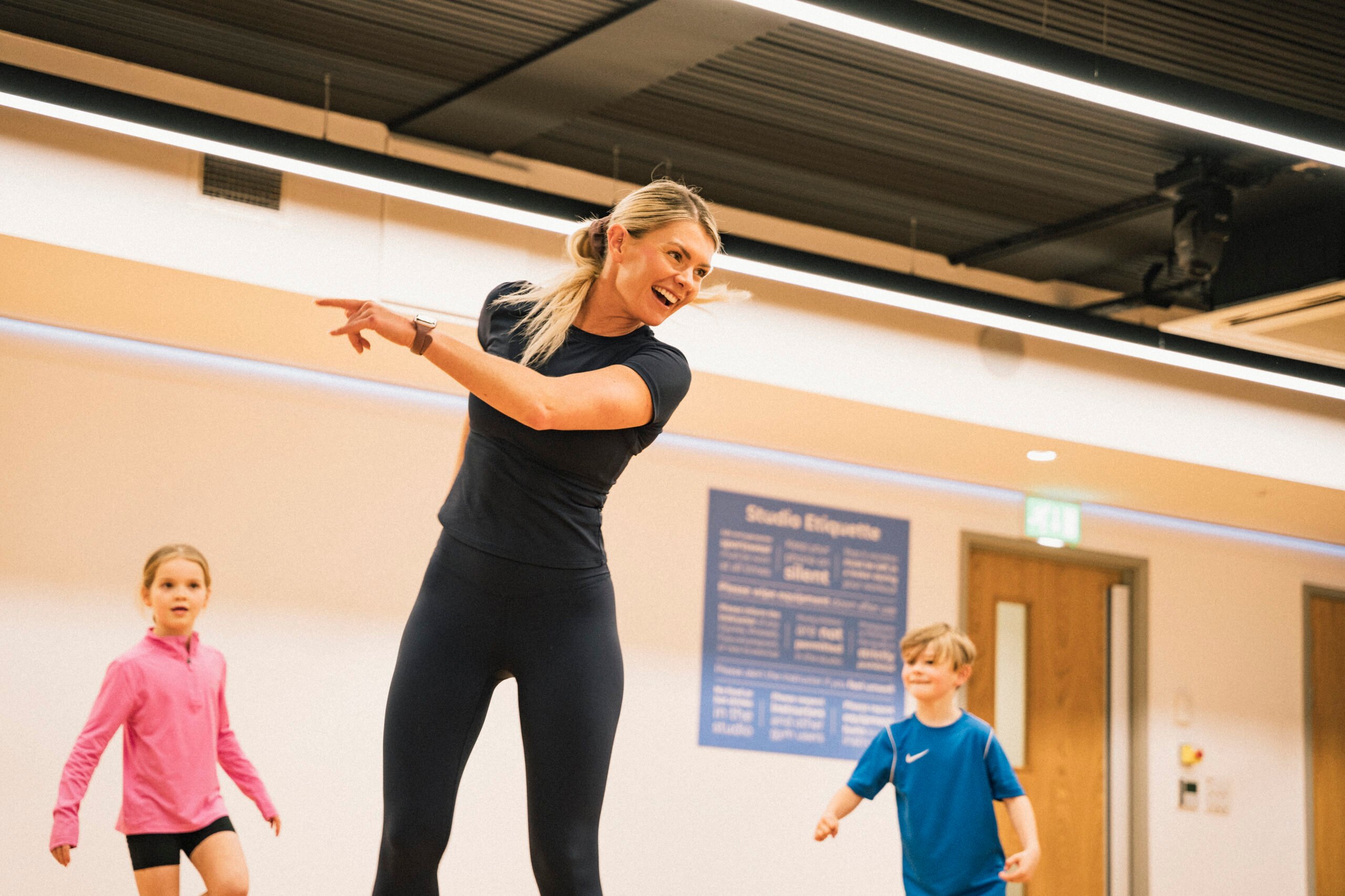 Danielle smiling while delivering a family dance class